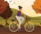 A Girl Rides a Bike in the Autumn Season